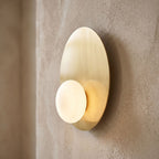 Metal Disc and Opal Glass Wall and Ceiling Light, close view at 45 degrees on a plaster wall