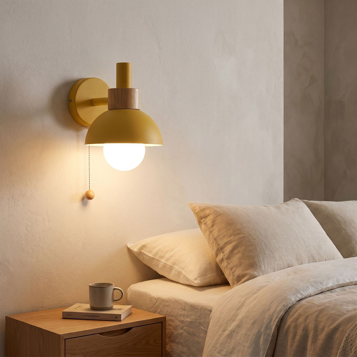 Metal Dome and Wood Collar Pull Chain Wall Light beside a bed