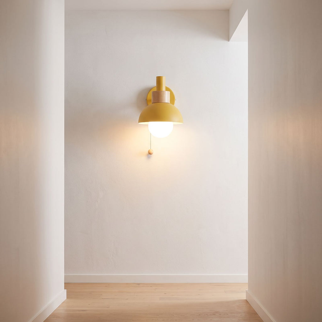 Metal dome pull chain wall light on a hallway wall