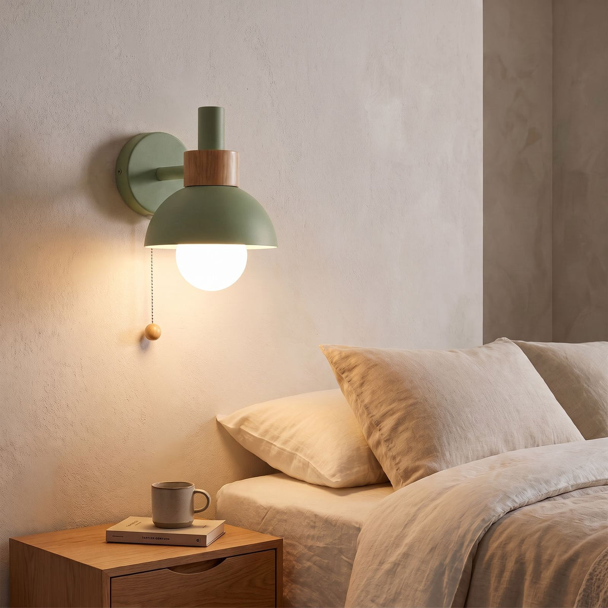 Metal Dome and Wood Collar Pull Chain Wall Light in green beside a bed
