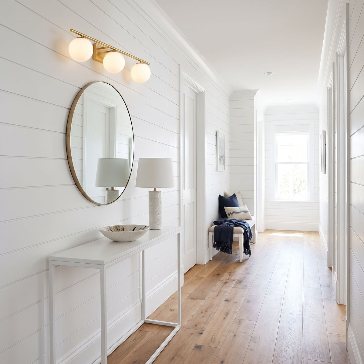 Milky Glass Globe Bar LED Vanity Wall Light with 3 globes above a hallway mirror