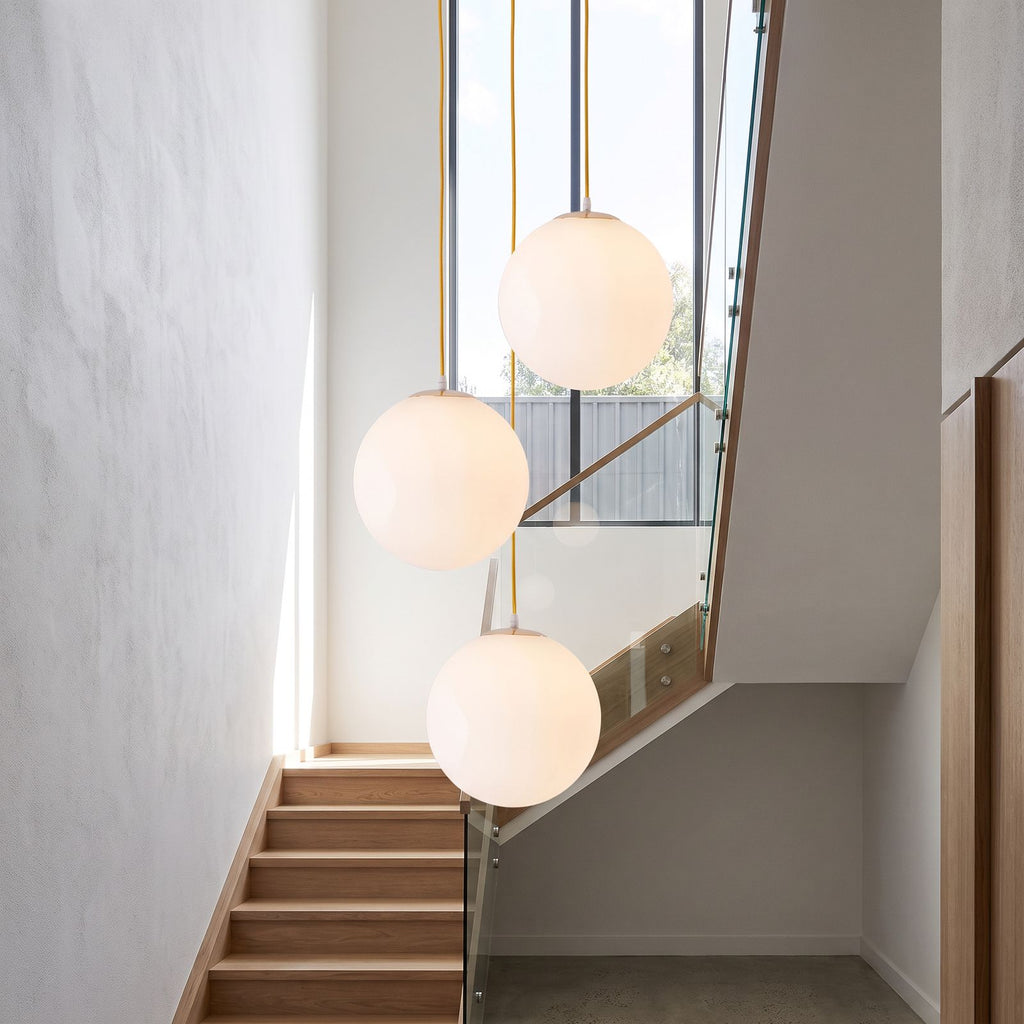 Milky Glass Globe Pendant Light in a group of three in a stairwell