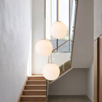 Milky Glass Globe Pendant Light in a group of three in a stairwell
