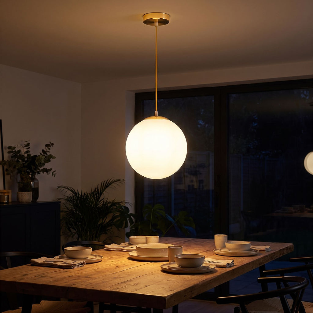 Milky Glass Globe Pendant Light above a dining table at night