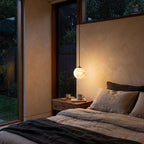 Mini Alabaster Globe LED Pendant Light hanging beside a bed