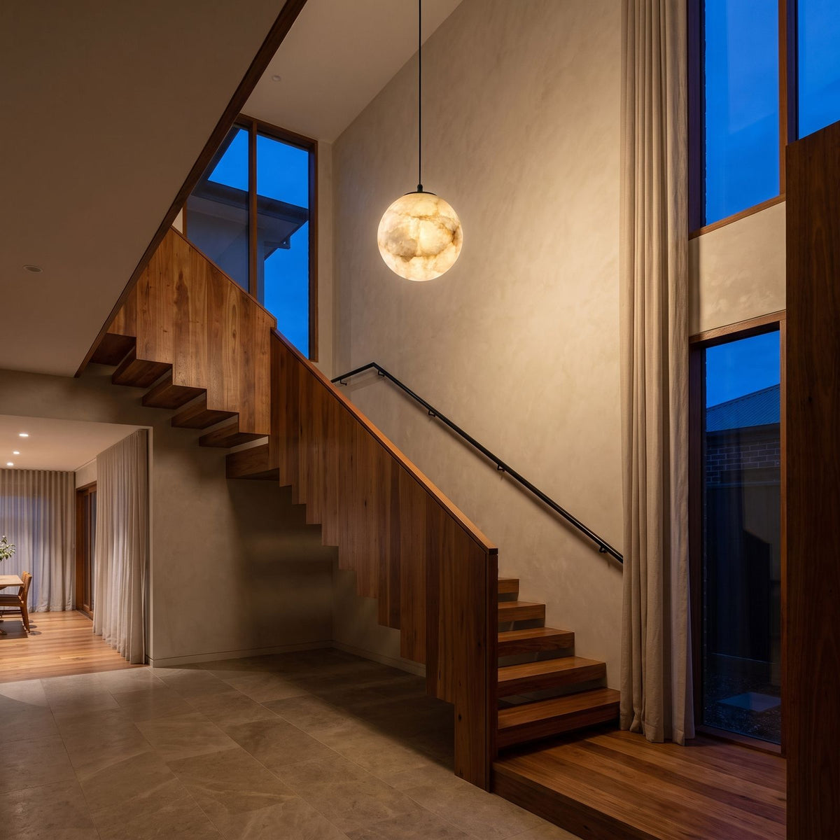 Mini Alabaster Globe LED Pendant Light in a double-height entry foyer