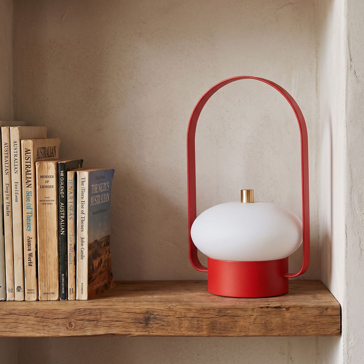 Mini Retro Portable Rechargeable Table Lamp on a shelf beside books