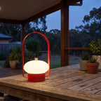 Mini Retro Portable Rechargeable Table Lamp on an outdoor table on a covered patio at dusk
