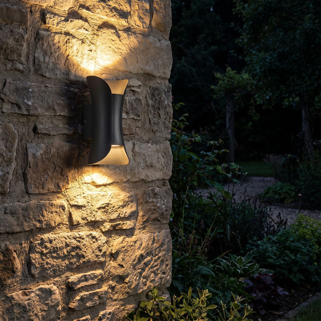 Minimalist Aluminium LED Outdoor Wall Light glowing on a garden wall at night