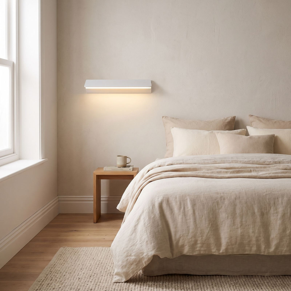 Minimalist White Metal Bar LED Wall Light on a bedroom wall beside the bed