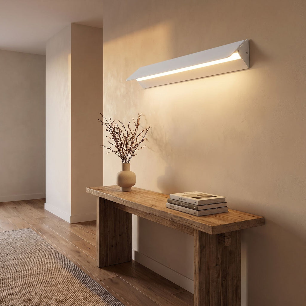 Minimalist White Metal Bar LED Wall Light in a hallway above a timber console