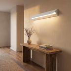 Minimalist White Metal Bar LED Wall Light in a hallway above a timber console