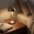 Mushroom Dome Metal Rechargeable Table Lamp on a bedside table