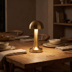 Gold mushroom dome table lamp on a dining table at night