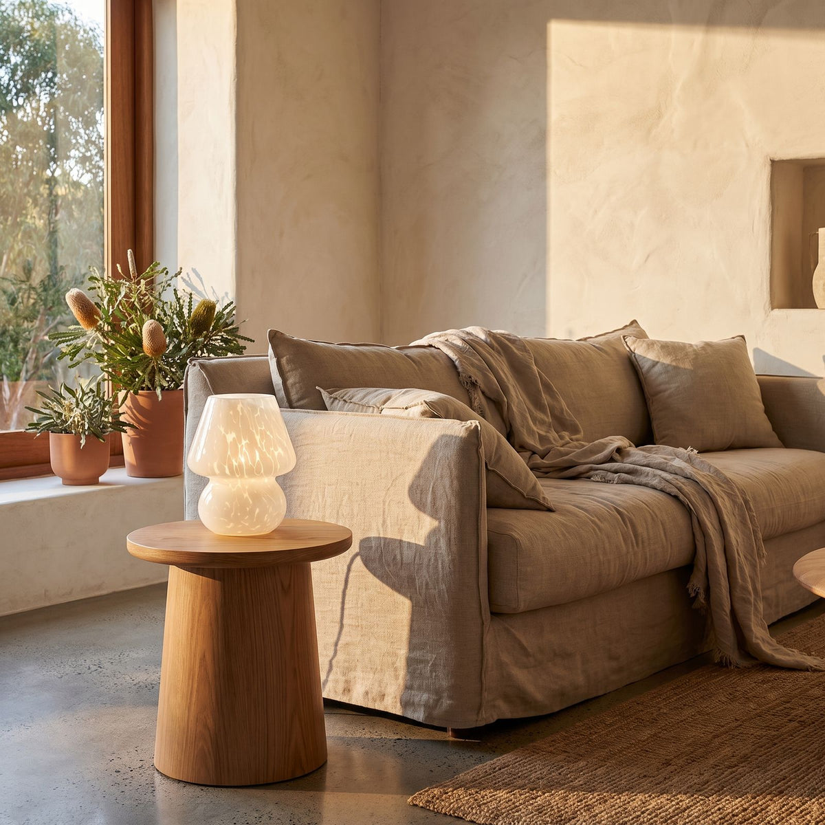 Mushroom Glass Table Lamp on a side table beside a sofa