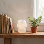 Mushroom Glass Table Lamp on a shelf beside books