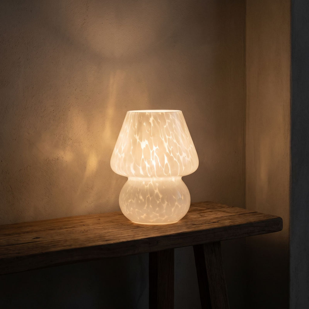Mushroom Glass Table Lamp glowing on a timber console at night