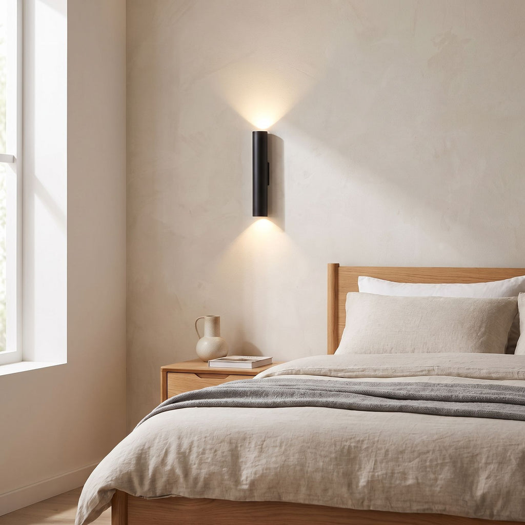 Narrow Aluminium Bar Up Down Wall Light on a bedroom wall beside the bed