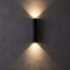 Narrow Aluminium Bar Up Down Wall Light glowing on a plaster wall at night