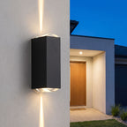 Narrow Beam Aluminium Up Down Outdoor Wall Light on a concrete facade at dusk