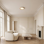 Natural Travertine LED Oyster Ceiling Light, Ø50 cm, flush on the ceiling of a classic panelled living room with a fireplace