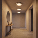 Three Natural Travertine LED Oyster Ceiling Lights, Ø30 cm, in a row on an entry hallway ceiling