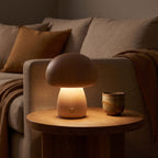 Wood mushroom touch LED table lamp on a side table beside a sofa