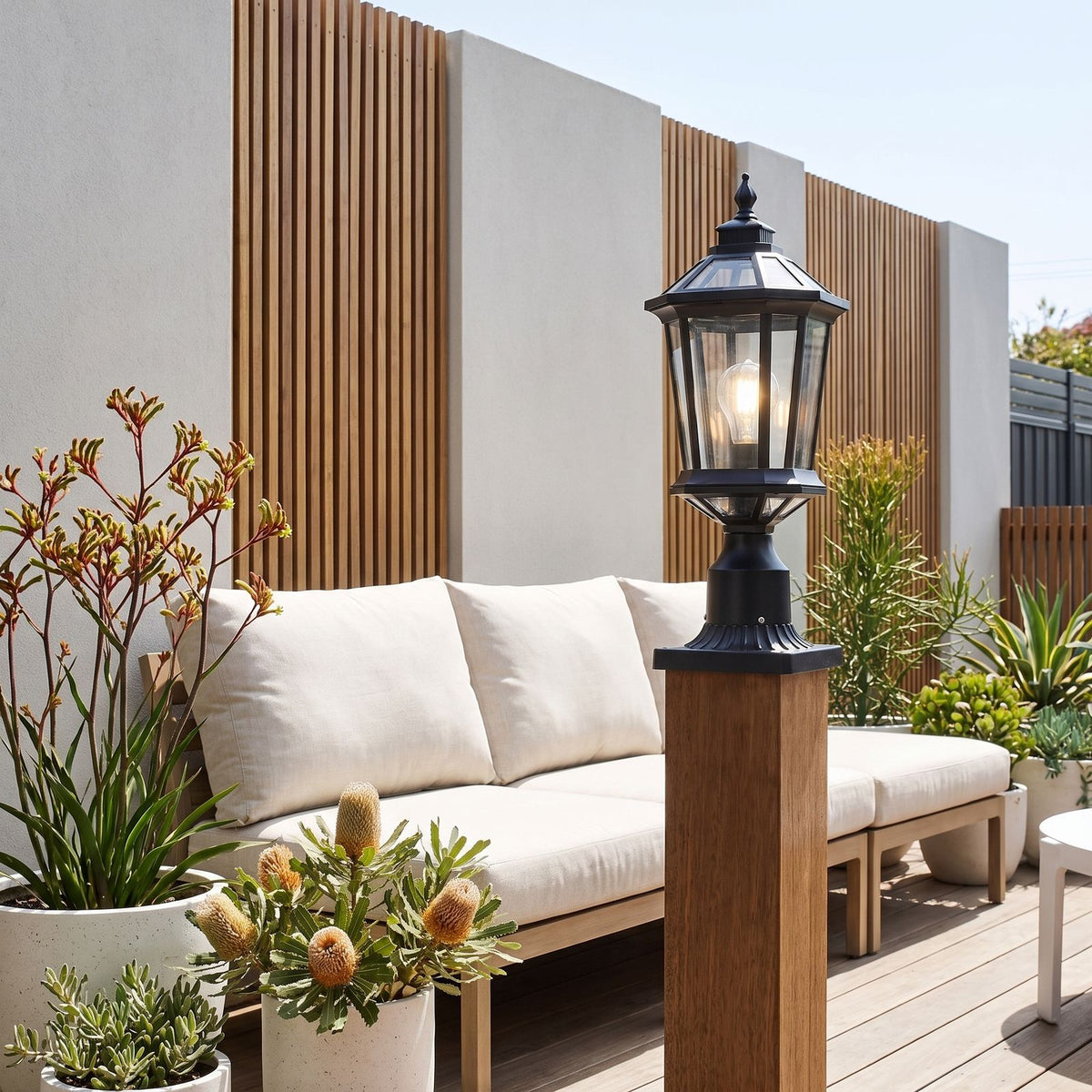 Octagonal Clear Glass Lantern Pillar Light on a timber deck post in daylight