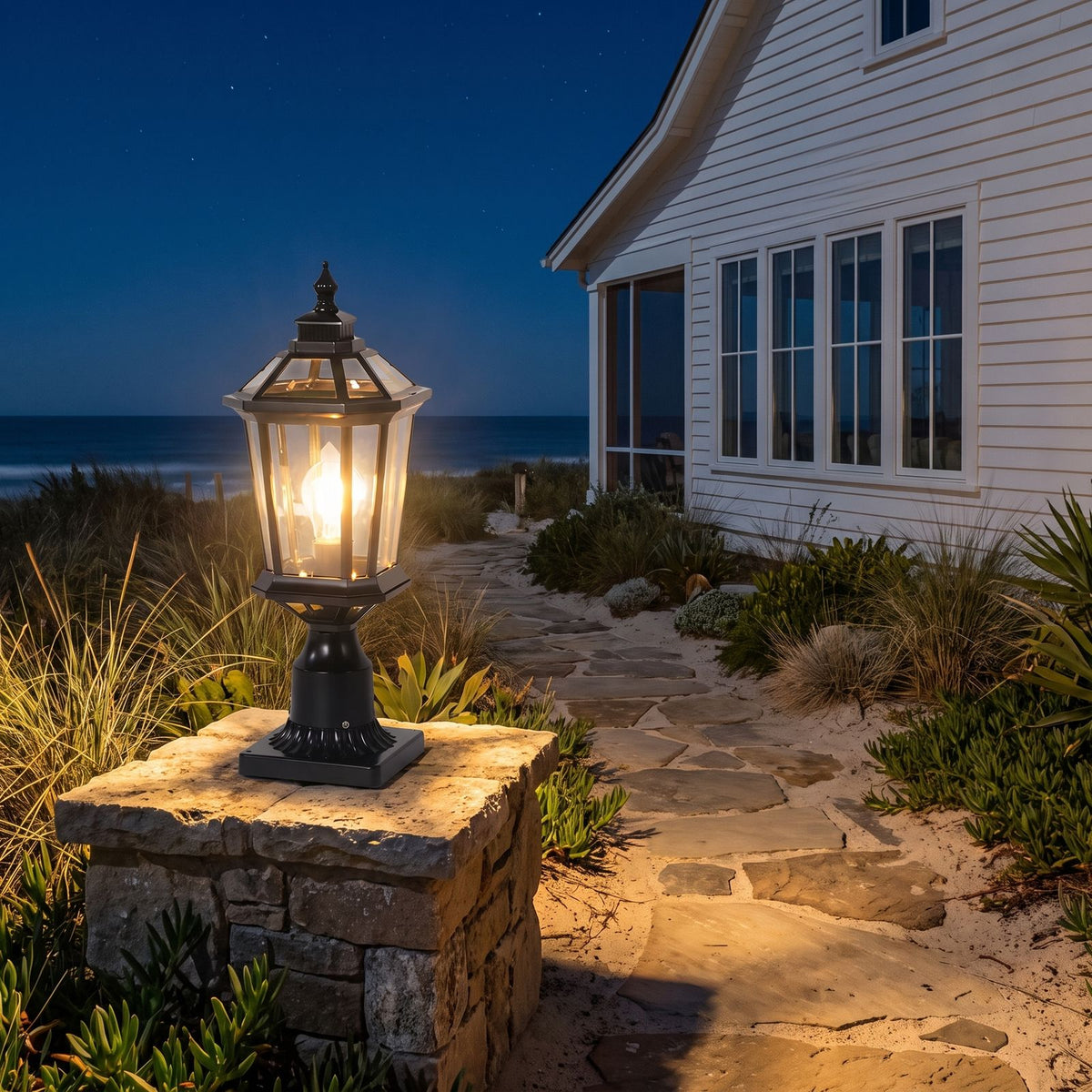 Octagonal Clear Glass Lantern Pillar Light on a garden wall pillar at night