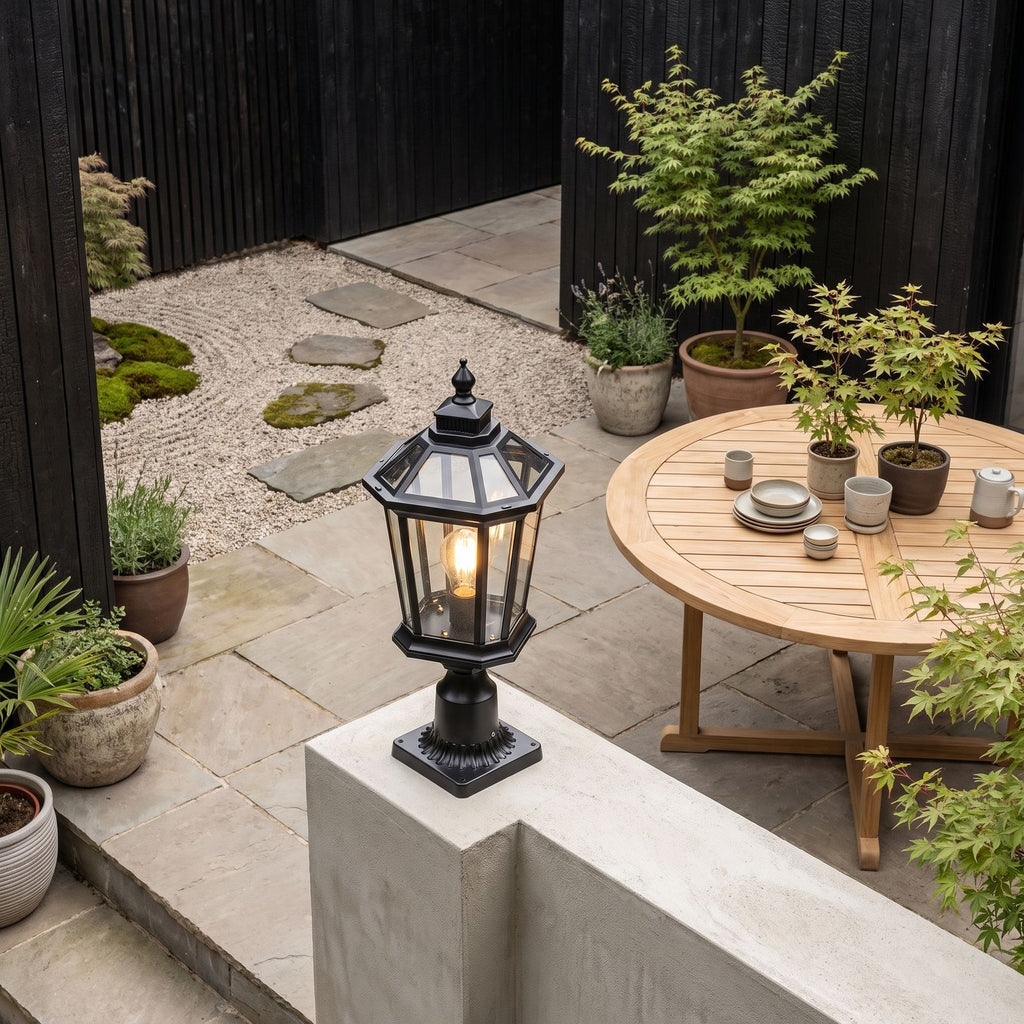 Octagonal Clear Glass Lantern Pillar Light on a courtyard terrace pillar in daylight