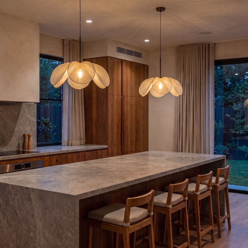 A pair of Open Petal Fabric Flower Pendant Lights over a stone kitchen island