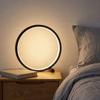 Open Ring LED Touch Dimming Table Lamp on a bedside table