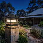 Open Square Frame Stainless Steel Deck Post Light on a garden wall pillar at night