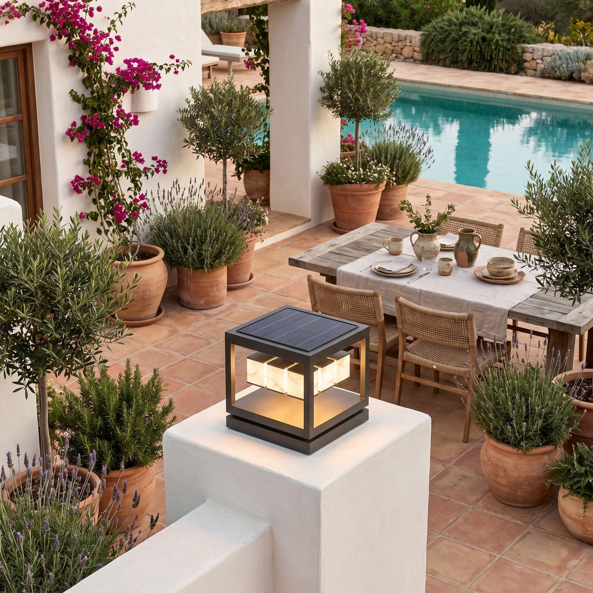 Open Square Frame Stainless Steel Deck Post Light on a courtyard terrace pillar in daylight