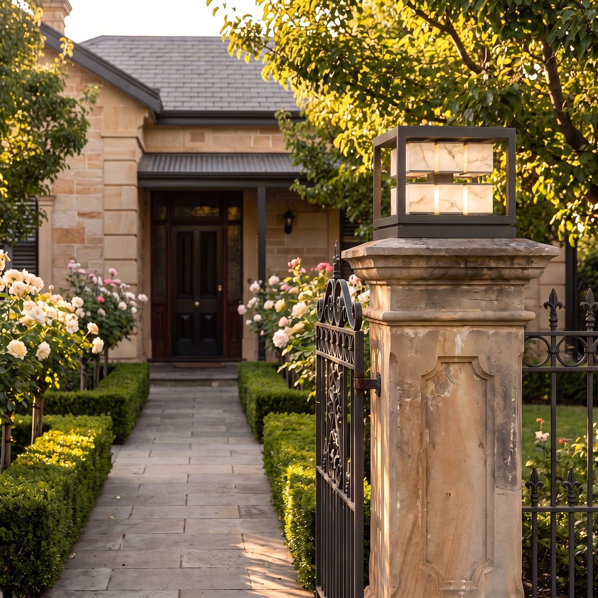 Open Square Frame Stainless Steel Deck Post Light double layer version on a front gate pillar at dusk