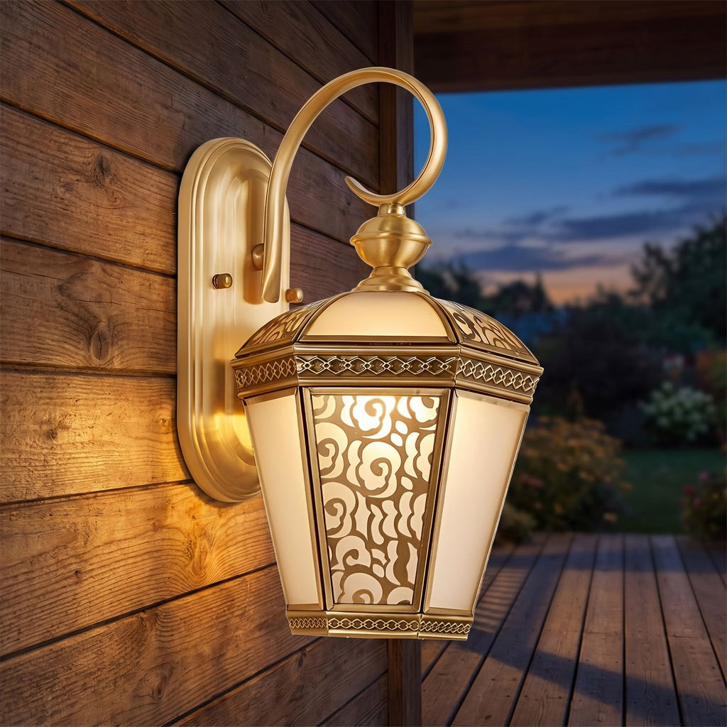 Ornate Brass and Glass Outdoor Wall Light on a porch wall at dusk