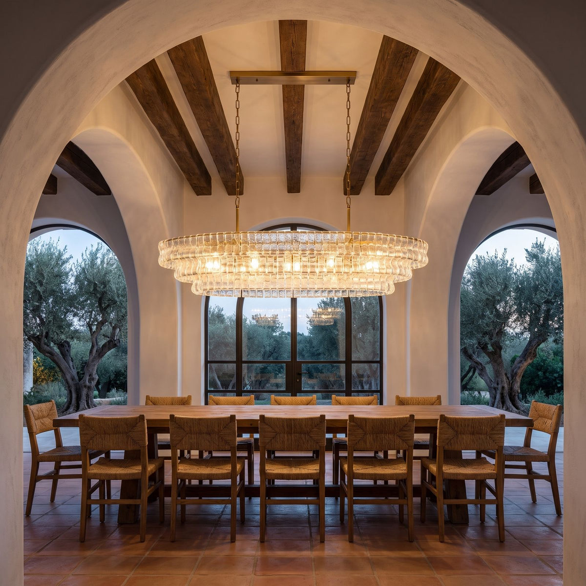 Oval Tiered Textured Glass Chandelier, 4 rows, above a long dining table