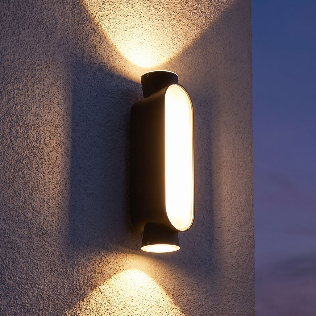 Oval Up Down Acrylic Outdoor Wall Light on a porch wall at dusk