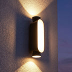 Oval Up Down Acrylic Outdoor Wall Light on a porch wall at dusk