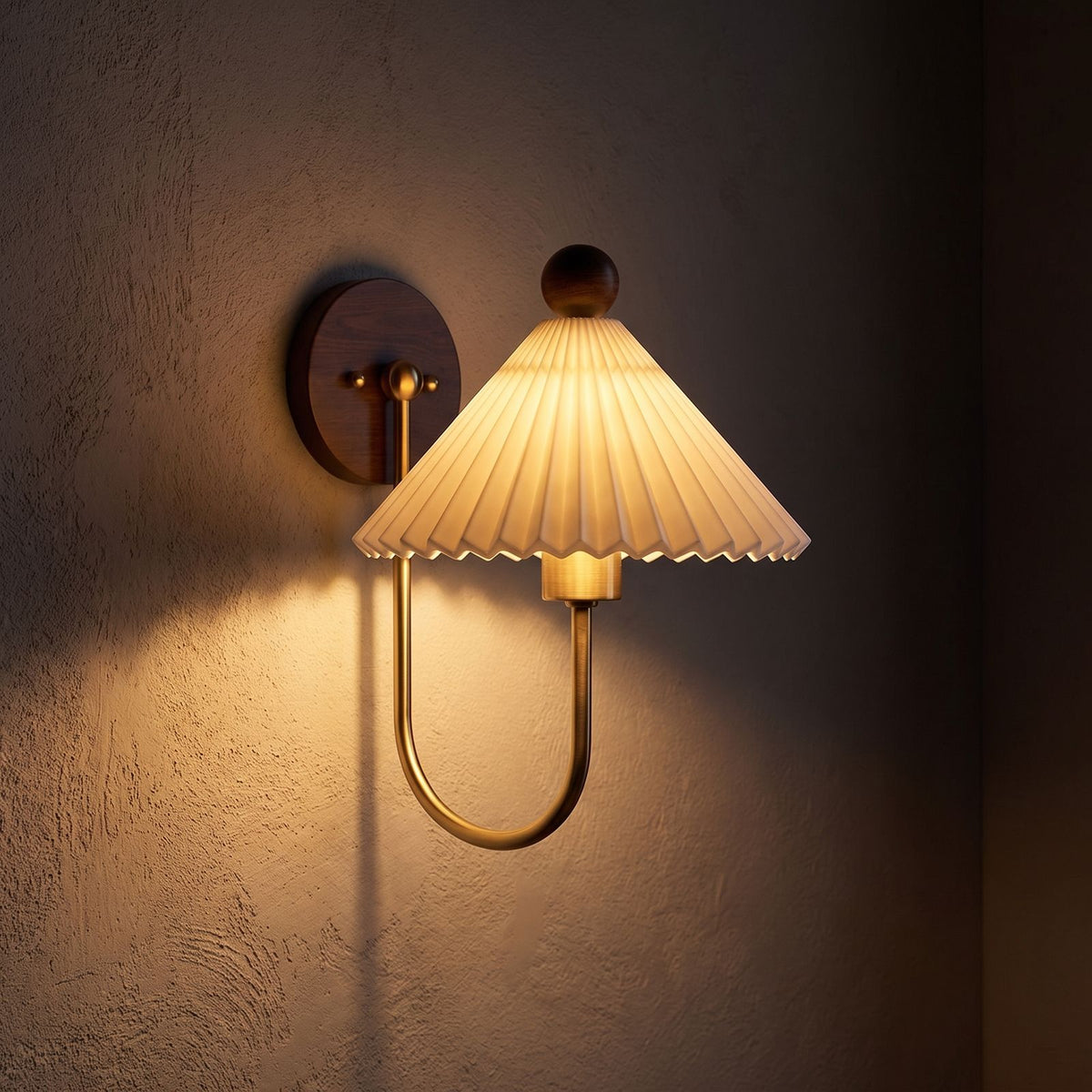 Pleated Ceramic Shade Bedside Wall Light glowing on a plaster wall at night
