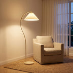Pleated Fabric Shade Arc Floor Lamp beside an armchair in a living room corner