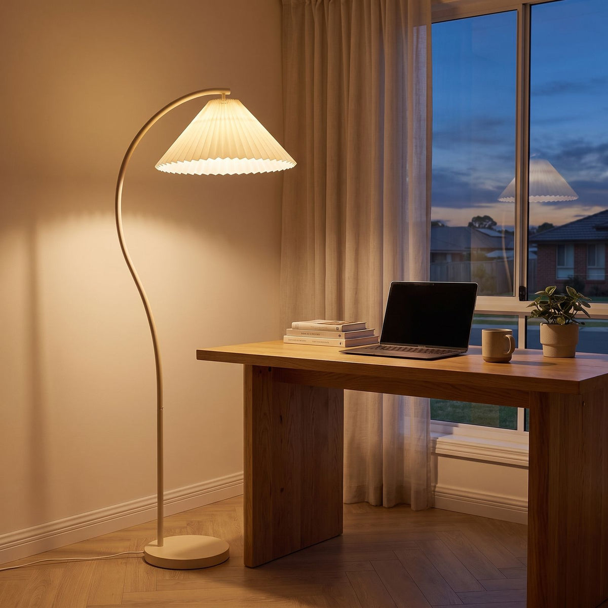 Pleated shade arc floor lamp in a home office corner beside a desk