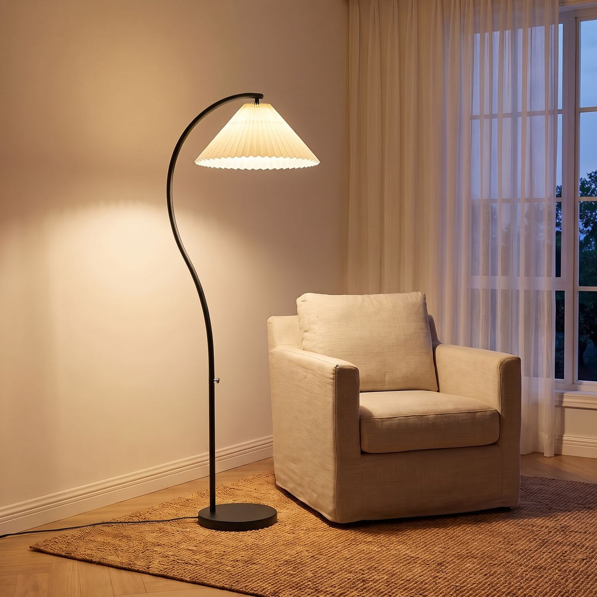 Pleated Fabric Shade Arc Floor Lamp with a black stem beside an armchair in a living room