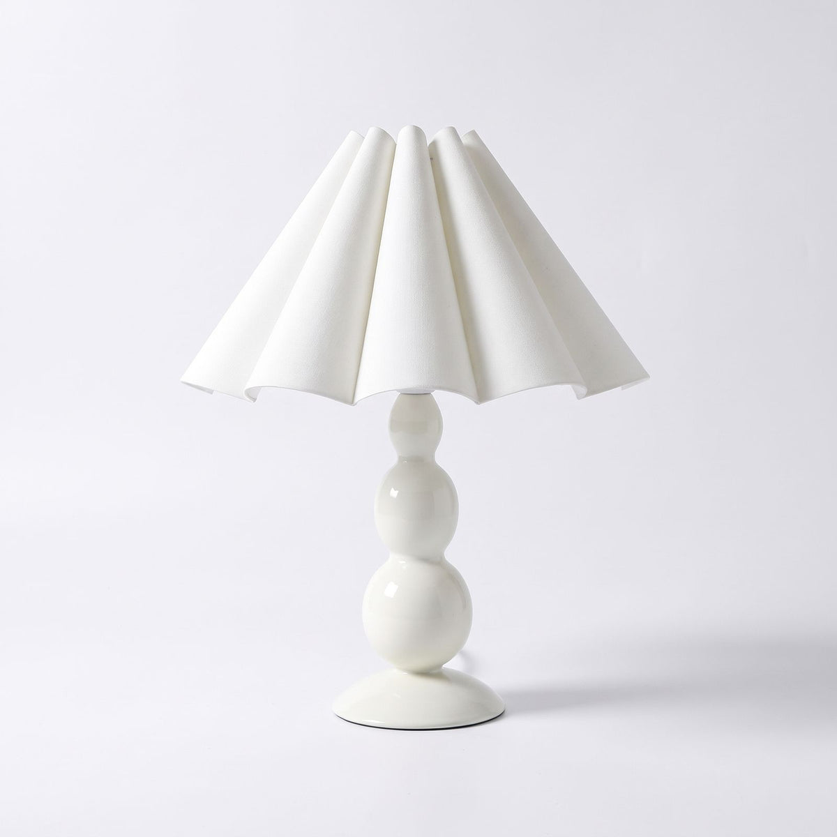 Scalloped Pleated Shade Bobbin Table Lamp in white on a white background