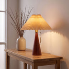 Pleated shade table lamp with walnut cone base on an entry console