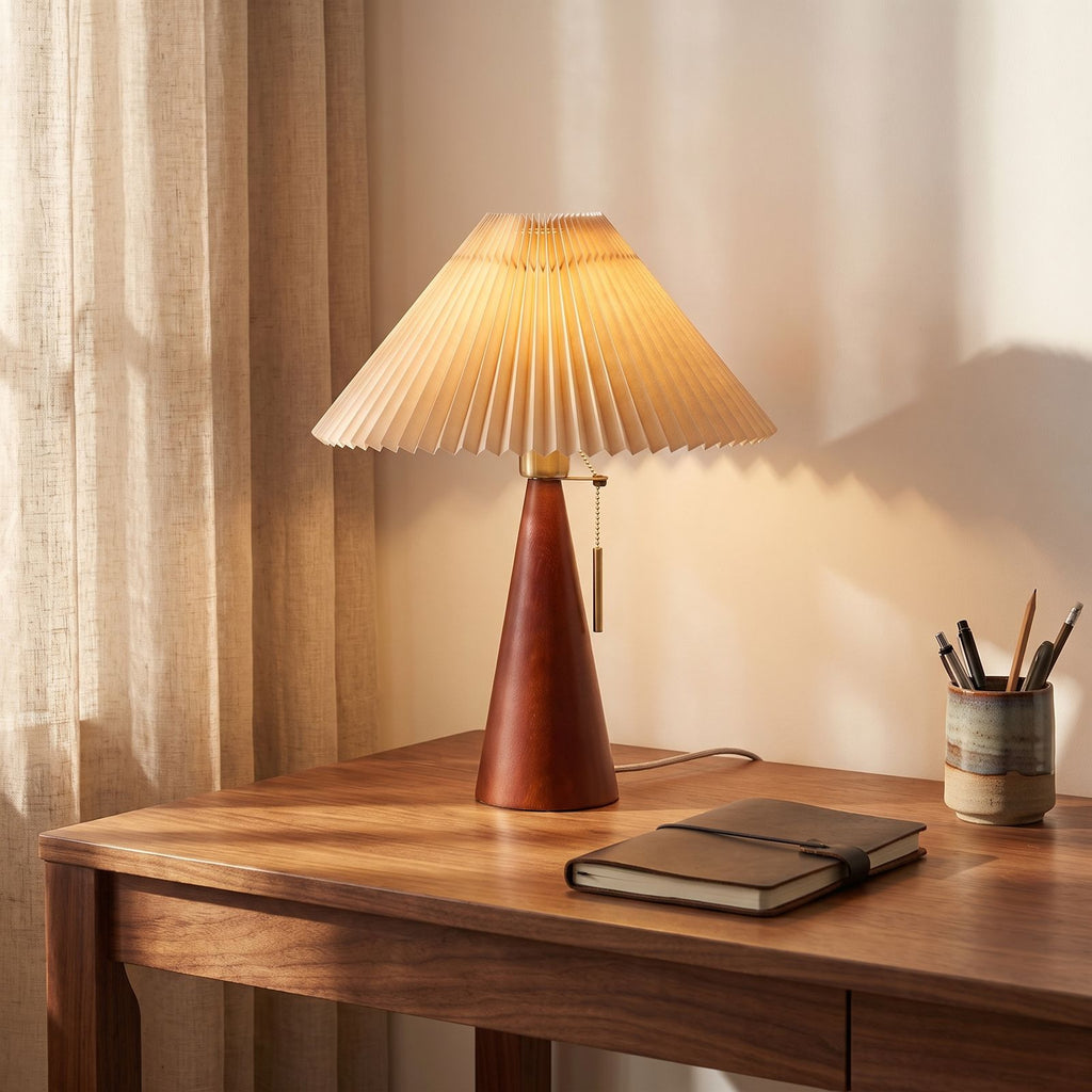 Pleated shade table lamp with walnut cone base on a home office desk