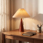 Pleated shade table lamp with walnut cone base on a home office desk
