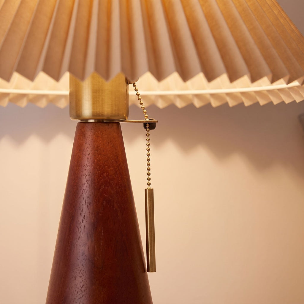 Close-up of the walnut base, brass collar and pull chain