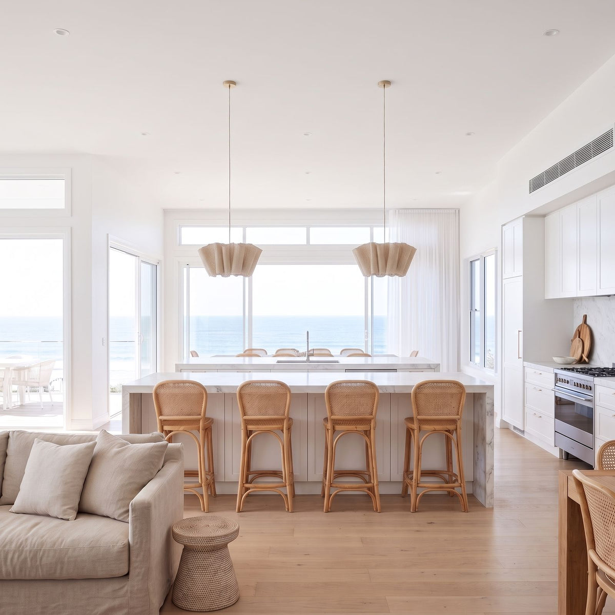 Two Pleated Wave Linen LED Pendant Lights, Ø40 cm, above a marble kitchen island in a coastal home