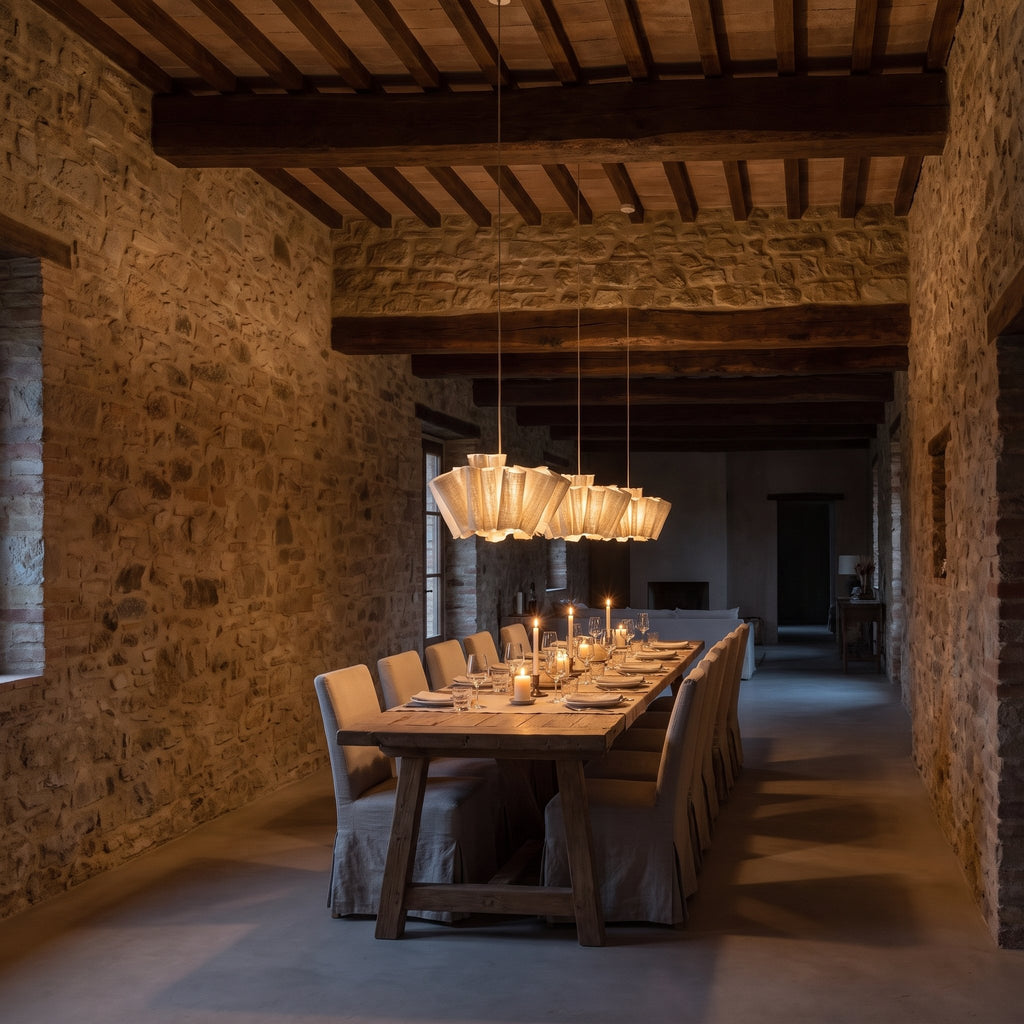 Three Pleated Wave Linen LED Pendant Lights, Ø40 cm, in a row above a long dining table in a stone villa